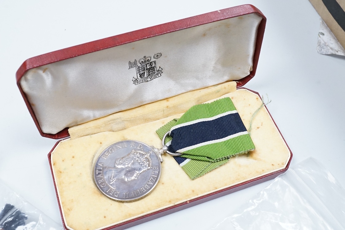A cased ERII Colonial Police Force Medal for Meritorious Service awarded to John F. Brown, Asst. Supt. Kenya Police., together with a WWII miniature medal set including a General Service Medal with a clasp for Palestine